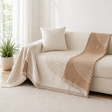 Tan reverse face of the arch lines cover draped over the couch arm
