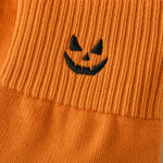 Macro of the embroidered pumpkin and ribbed cuff seam