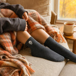 Charcoal skull Halloween socks with a plaid fall blanket