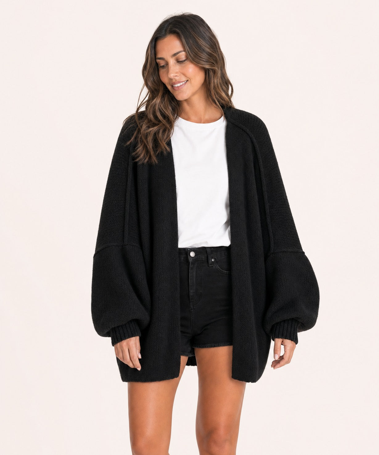 Black oversized open-front knit cardigan, front view on model :: The model is 5'6" and wears a size M