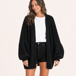 Black oversized open-front knit cardigan, front view on model :: The model is 5'6" and wears a size M