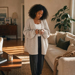 Woman at home in the oatmeal cardigan holding a warm mug :: The model is 5'6" and wears a size M