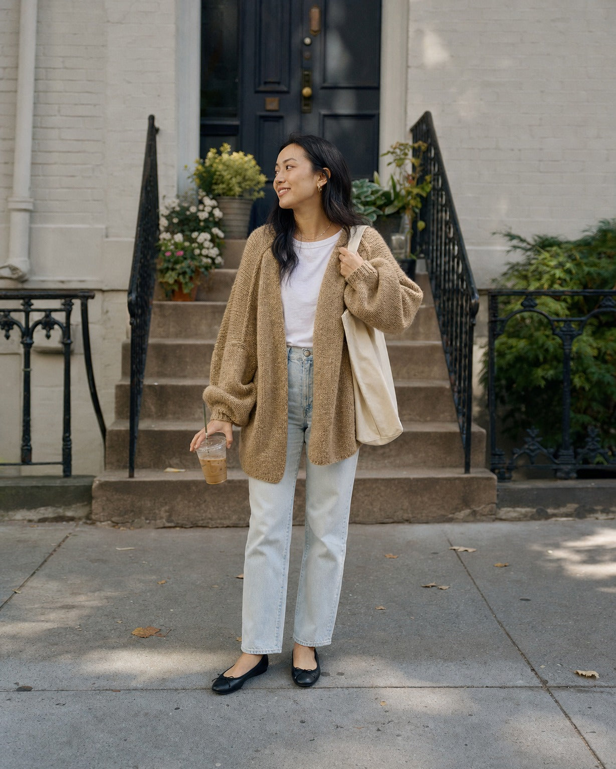 Petite woman wearing the camel cardigan in size S on brownstone steps :: The model is 5'2" and wears a size S